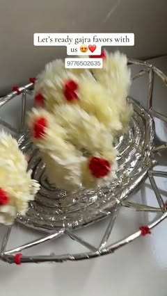 Gajra favours with red buds in a silver tray